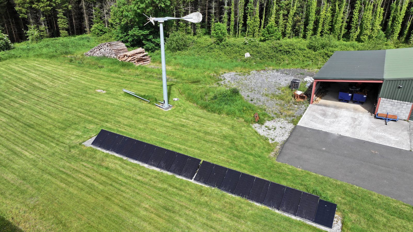 The 2020 wind turbine standing beside ground-mounted solar panels